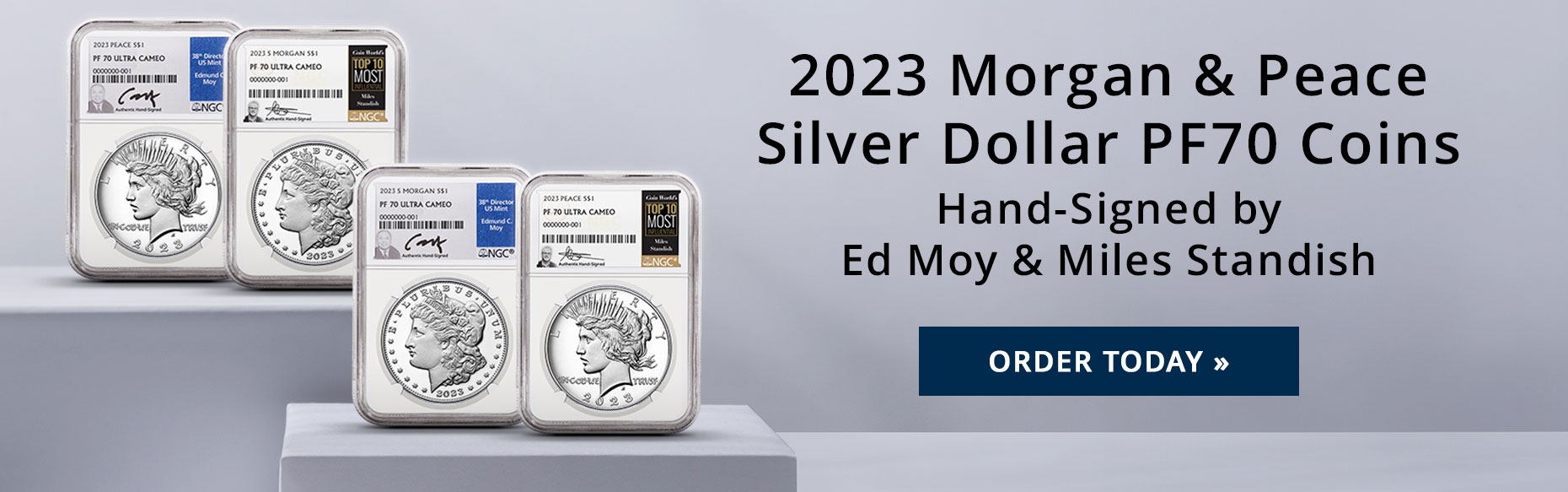 2023 Silver Morgan and Peace Dollars with labels hand-signed by Ed Moy and Miles Standish on a studio backdrop.